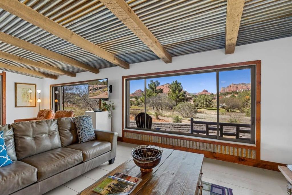 a living room with a couch and a table at Mid-century Ranch Home in Sedona with Fantastic Red Rock Views in Sedona