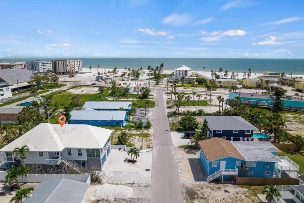 an aerial view of a beach with houses and the ocean at 144 Mango St in Fort Myers Beach