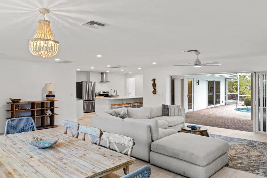 a living room with a couch and a table at Sanibel Serenity- NEW Gorgeous Near Beach Villa with Pool in Sanibel
