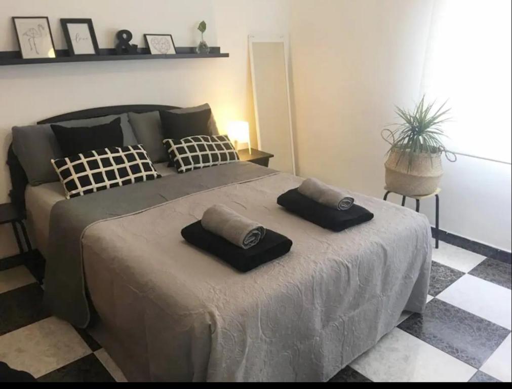 a bedroom with a bed with two pillows on it at habitación 1 en tercera planta sin ascensor no és piso entero a compartir baño y cocina in Fuengirola