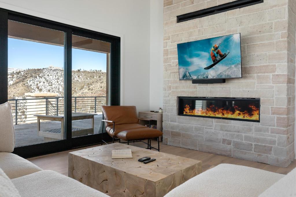 a living room with a stone wall with a fireplace at 1665 Cordillera Way in Edwards