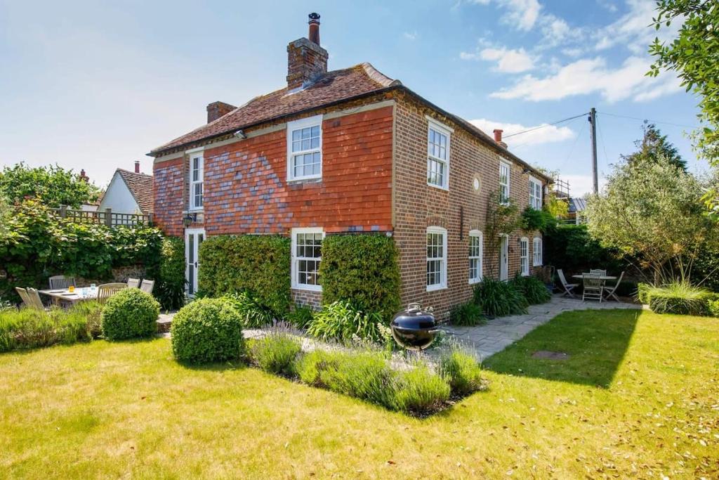a large brick house with a garden in the yard at Country cottage in pretty village quay views in Chichester