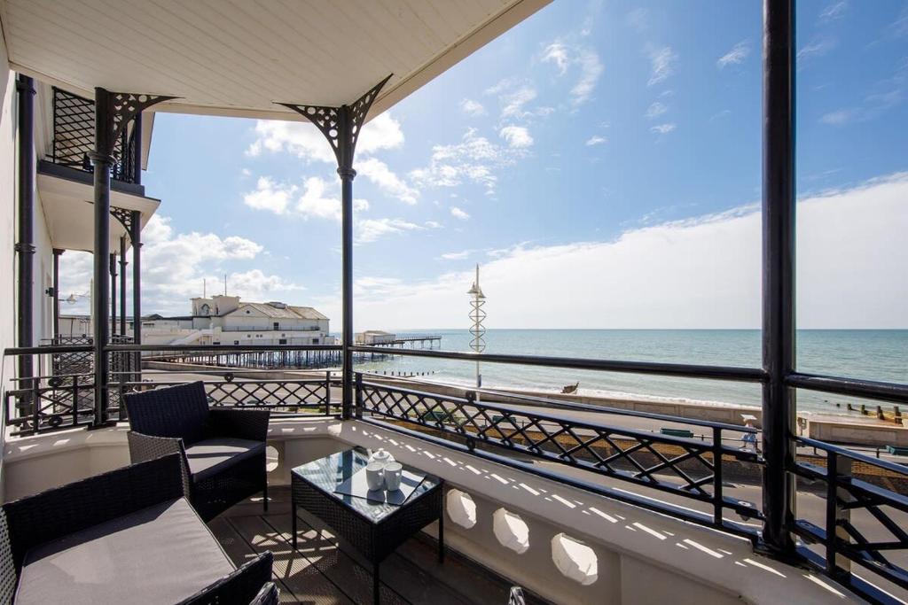 a balcony with a view of the beach at Panoramic sea views in beachfront apt w balcony in Bognor Regis