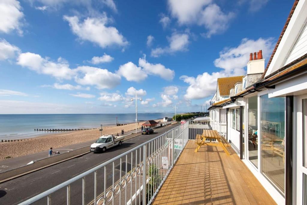 a balcony with a view of the beach at Stunning Beachfront Apt w Balcony & Sea Views in Bognor Regis