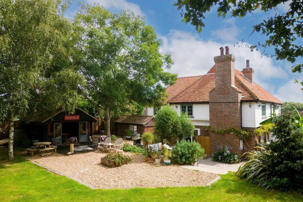 an old brick house with a garden in front of it at Tranquil Luxe in Country Cottage in Bosham