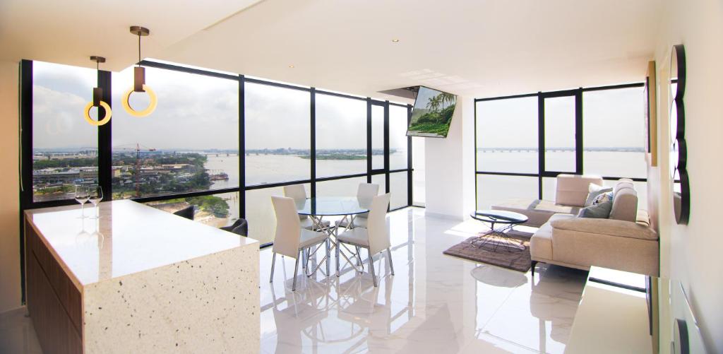a kitchen and living room with a view of the water at Suite 1202 Bellini, Puerto Santa Ana, Guayaquil in Guayaquil