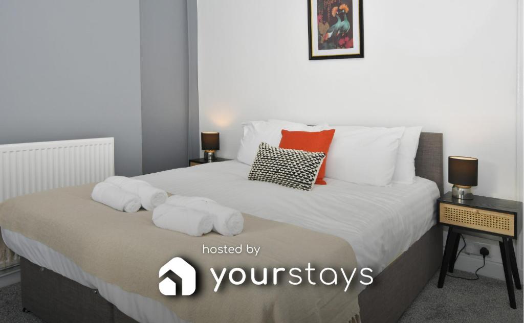 a bedroom with a bed with two pillows on it at Victoria House by YourStays, City Centre, free parking, sleeps 6 in Stoke on Trent