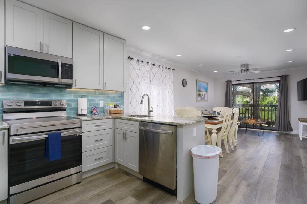 a kitchen with white cabinets and a counter top at Remodeled Corner Unit 2 2 Overlooking the Lagoon in Hilton Head Island