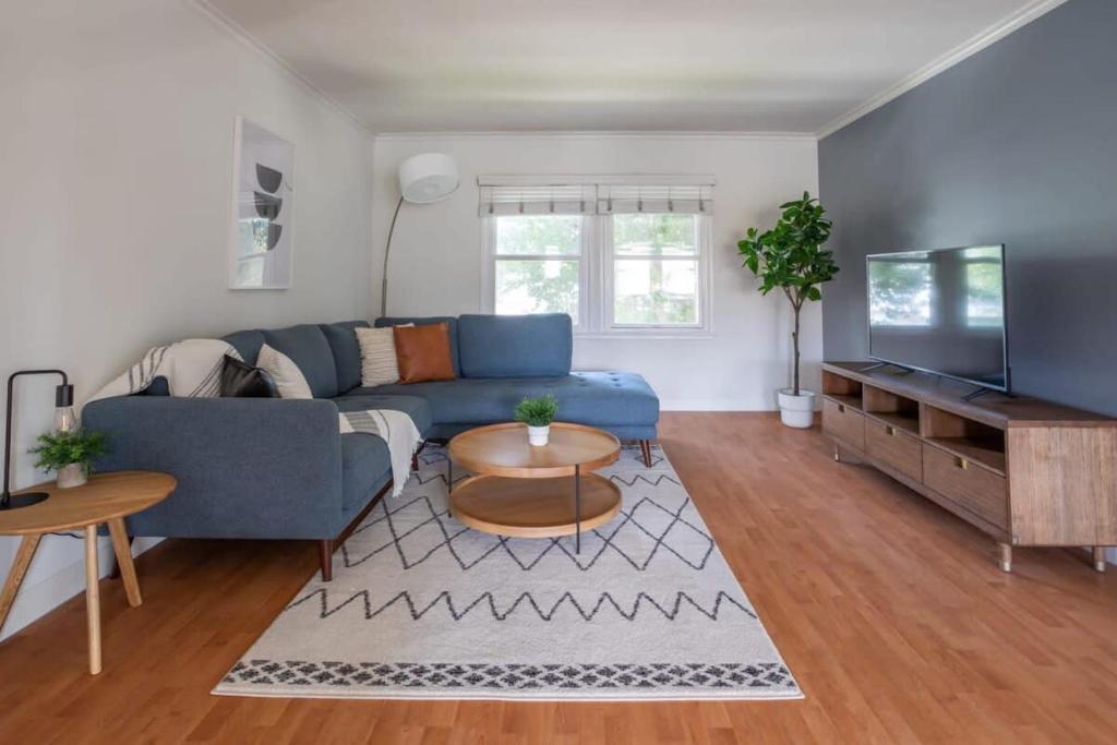 a living room with a blue couch and a tv at Cozy Massive 2BR Washer Dryer in Unit by LAX in Los Angeles