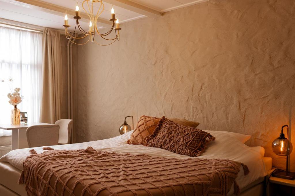 Postel nebo postele na pokoji v ubytování Boutique Hotel Elburg met Tapperij