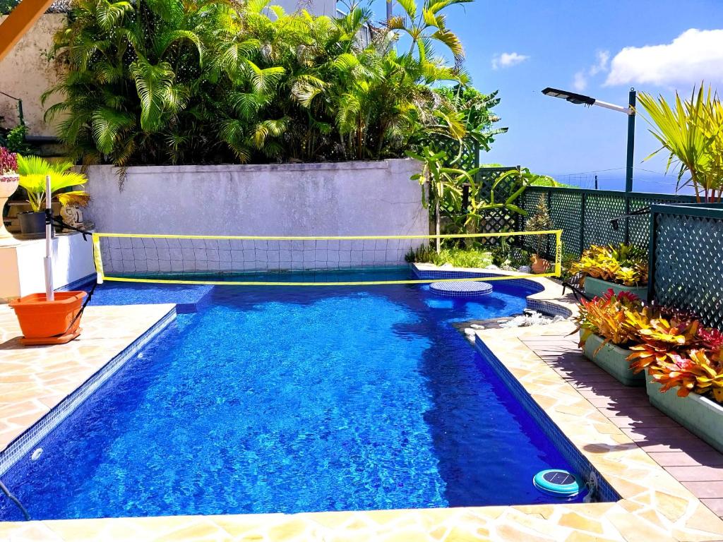 a swimming pool in the backyard of a house at TAHITI - Terevete Pool Studio in Arue