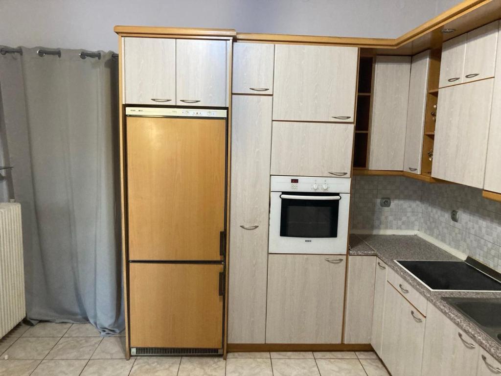 a kitchen with white cabinets and a yellow refrigerator at Central Village House in Lépoura