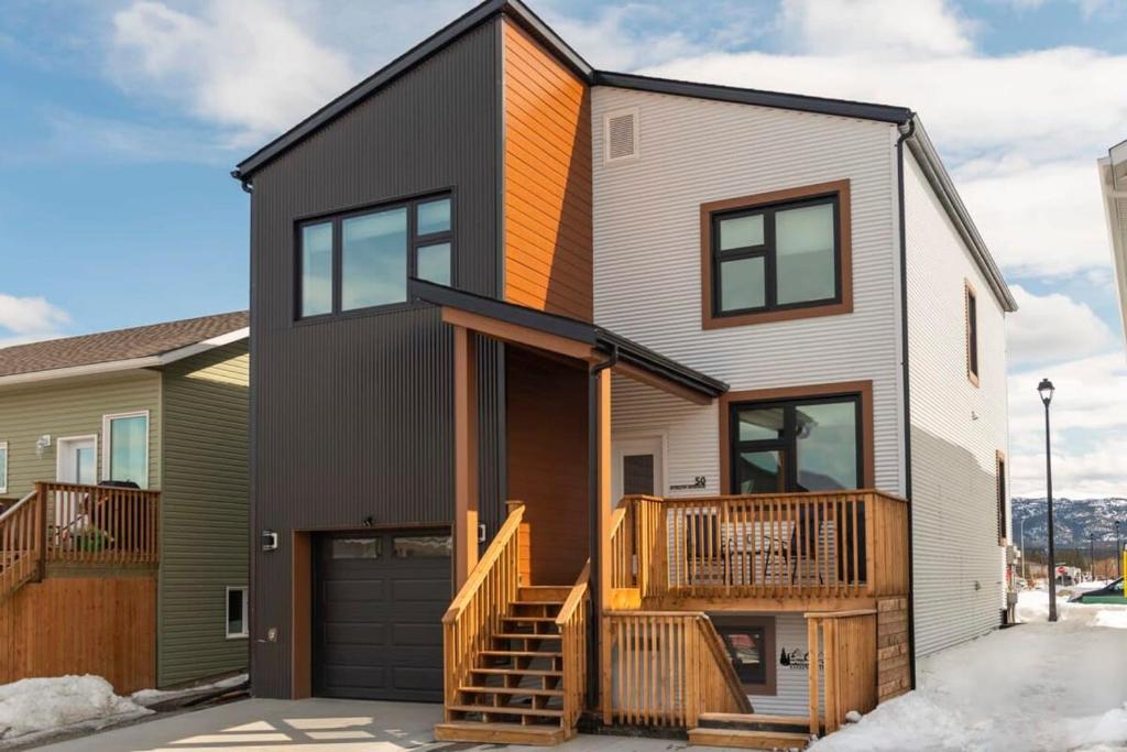 a contemporary house with a black and brown facade at NN - The Evelyn - Whistlebend 1-bed 1-bath in Whitehorse