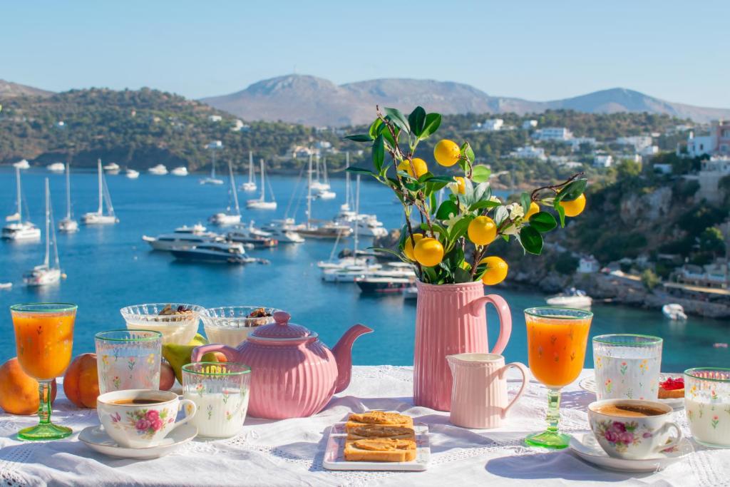 a table with tea and coffee and a view of a harbor at Leros Windmills in Panteli