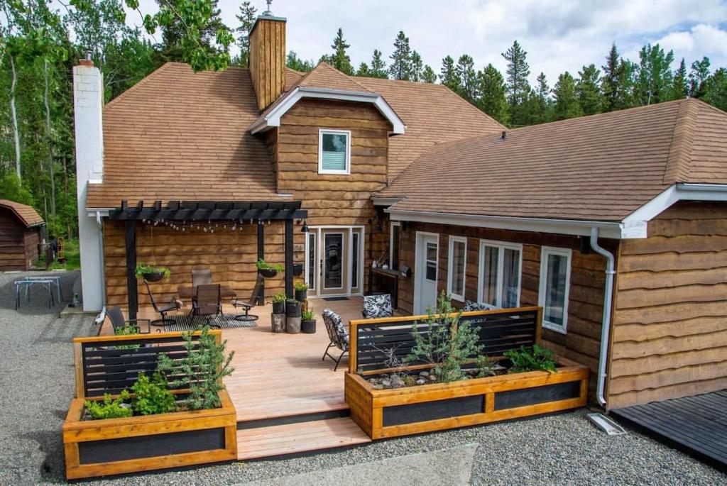 a house with a wooden deck in front of it at NN - The Den - Riverdale 1-bed 1-bath in Whitehorse
