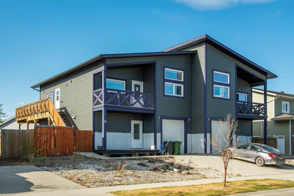 a black house with a car parked in front of it at NN The Lavendar B Whistlebend 1bed 1bath in Whitehorse