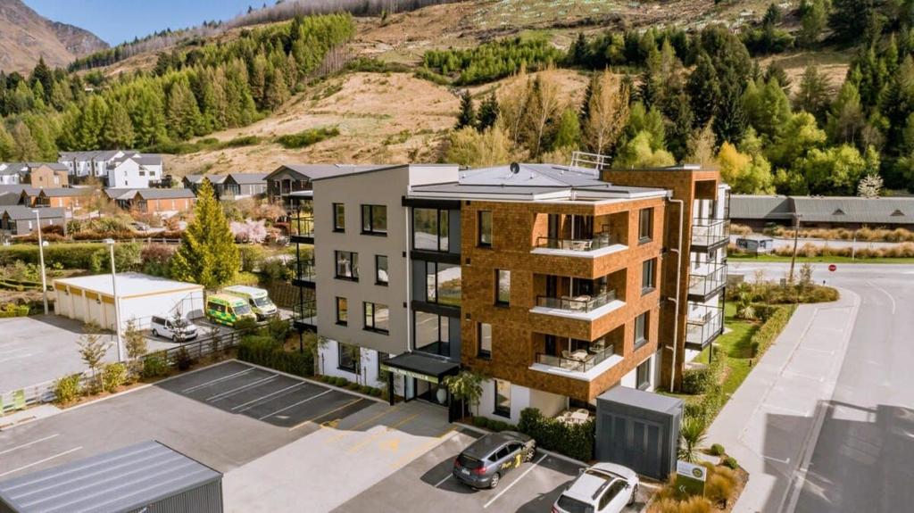an aerial view of a building with a parking lot at La Residence du Parc in Queenstown