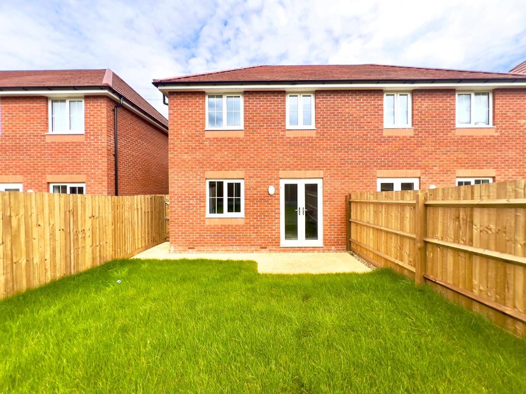a red brick house with a wooden fence at BRAND NEW 3 BEDROOM HOUSE WITH GARDEN AND FREE PARKING in Wednesbury