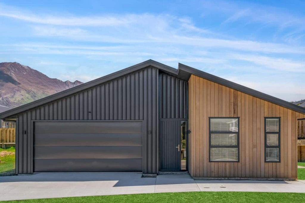 a large metal building with a garage at Vacations on Riverslea in Wanaka