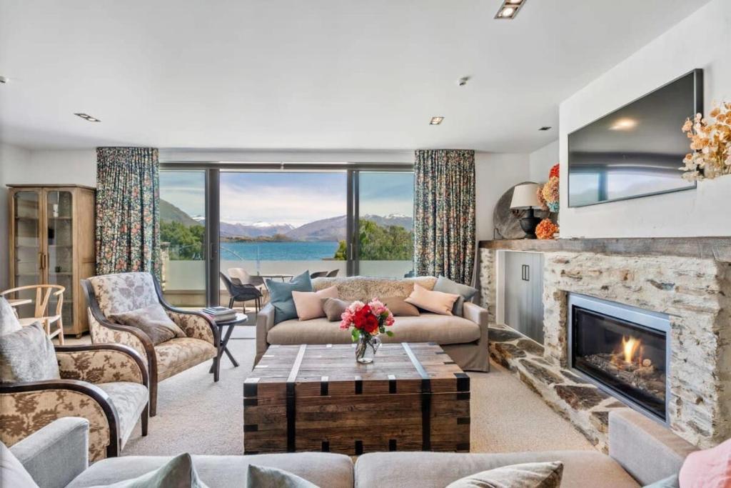 a living room filled with furniture and a fireplace at Pembroke Luxury Apartment in Wanaka