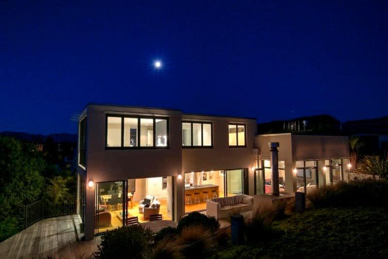 a house at night with the moon in the sky at Mataraki Magic in Wanaka