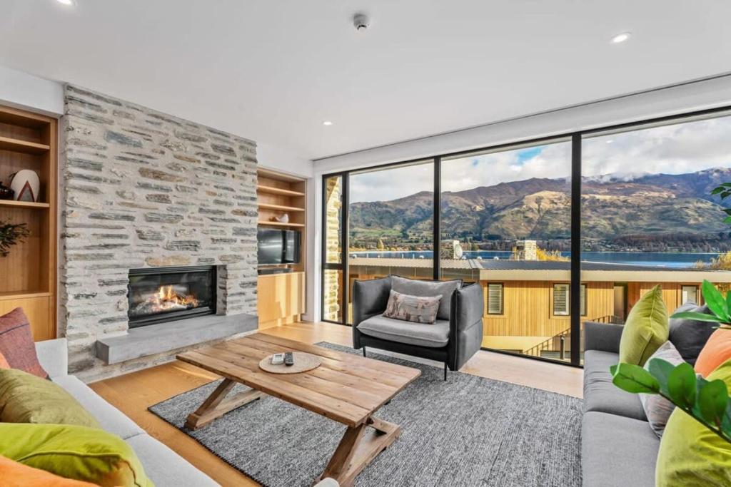 a living room with a couch and a fireplace at Lakeview Luxury Vista in Wanaka
