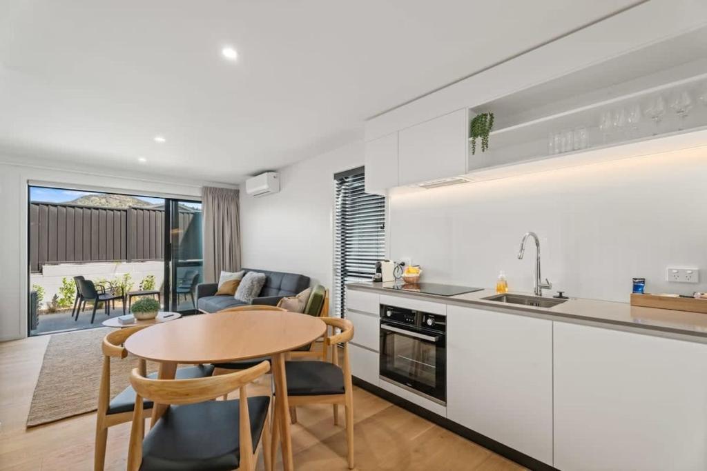 a kitchen and living room with a table and chairs at Rivers Abode in Albert Town
