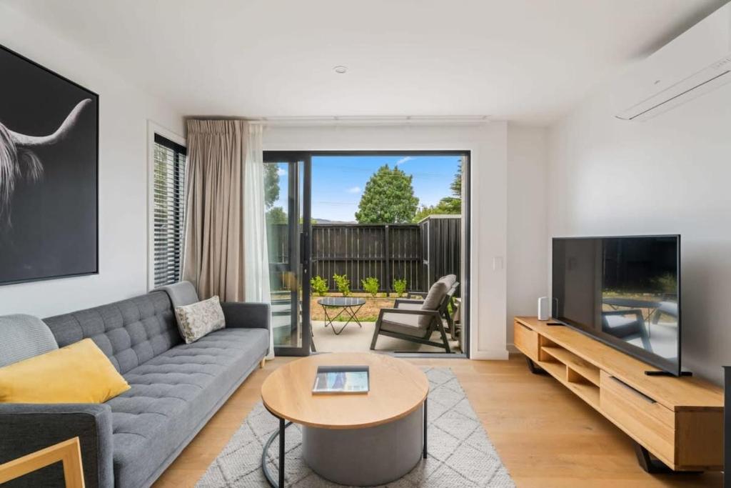 a living room with a couch and a tv at Adventure Riverside Retreat in Albert Town