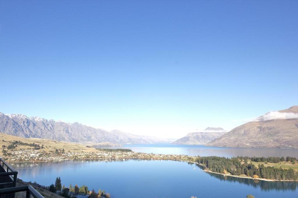 a view of a lake with mountains in the background at Modern 3 bedroom with stunning postcard views! in Queenstown