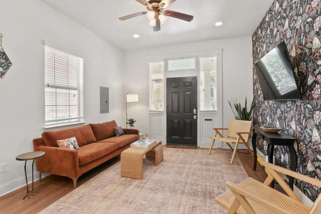 a living room with a brown couch and a ceiling fan at Fabulous Classy and Comfy 3BD 2BA Home and Parking in New Orleans