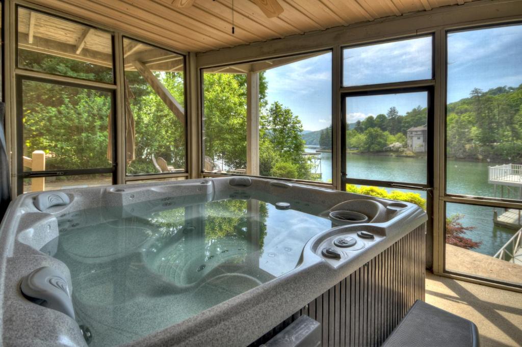 a large bath tub in a room with windows at Jump Right In in Blue Ridge