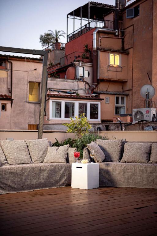 a living room with a couch on top of a building at Nikis Collection Trastevere in Rome