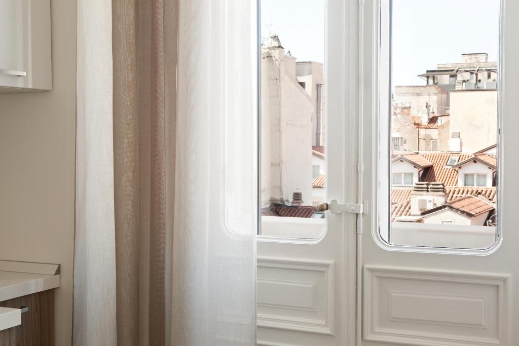 an open door with a view of a city at Palazzo Talenti 1907 in Trieste
