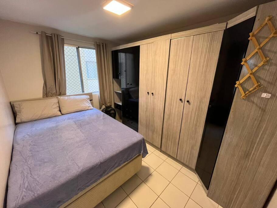 a small bedroom with a bed and a closet at AP Condomínio Fechado in São José dos Pinhais