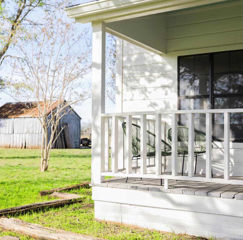 a porch of a house with a bench on it at Morris Ranch in Fredericksburg