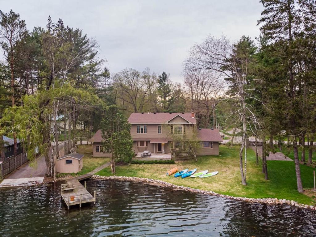 an aerial view of a house on a lake at Lake House Vacation Sleeps 12 Private Dock in Waupaca