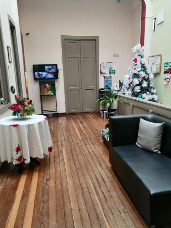 a living room with a christmas tree and a couch at Boutique del cafe in Manizales