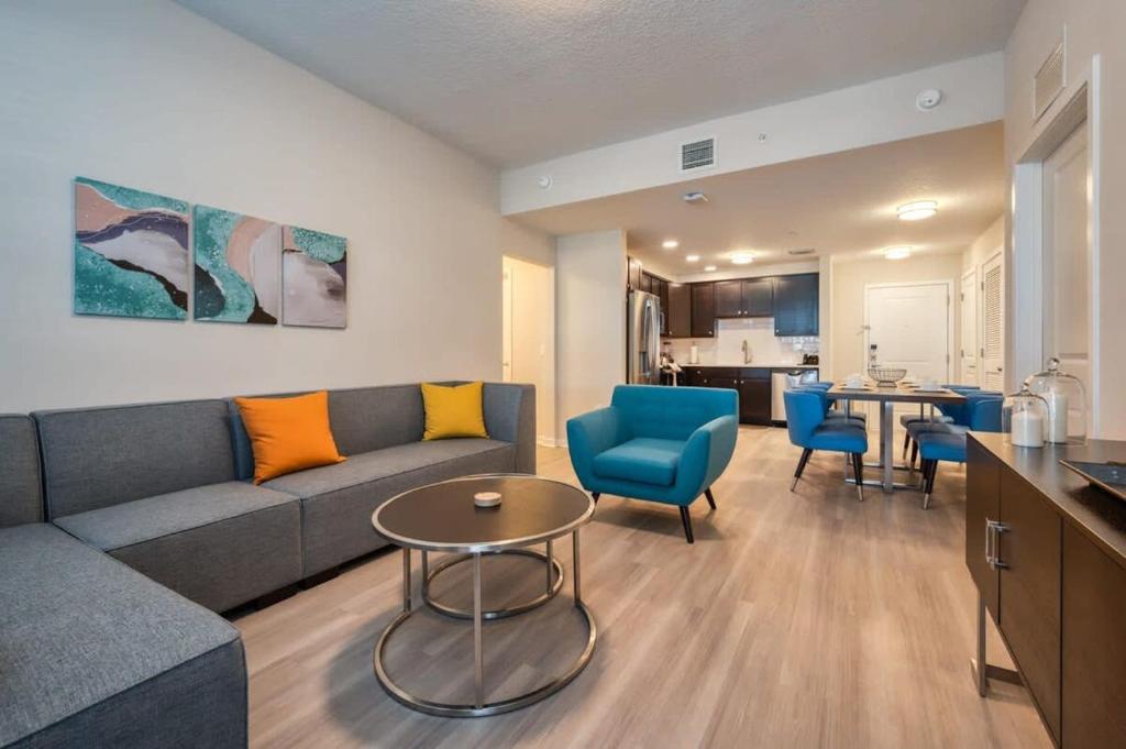 uma sala de estar com um sofá, cadeiras e uma mesa em Leisure & Business Oasis-Near Convention Center em Orlando