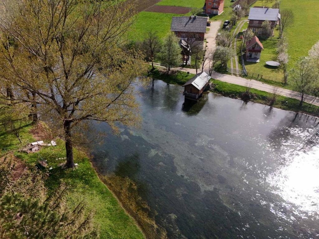 an aerial view of a river with a boat in it at River View Tiny House with Garden in Šipovo