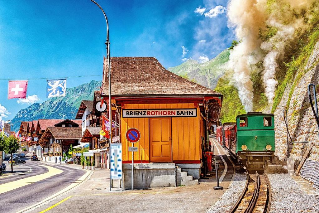 a train on the tracks next to a train station at Apartment am schönen Brienzersee in Brienz