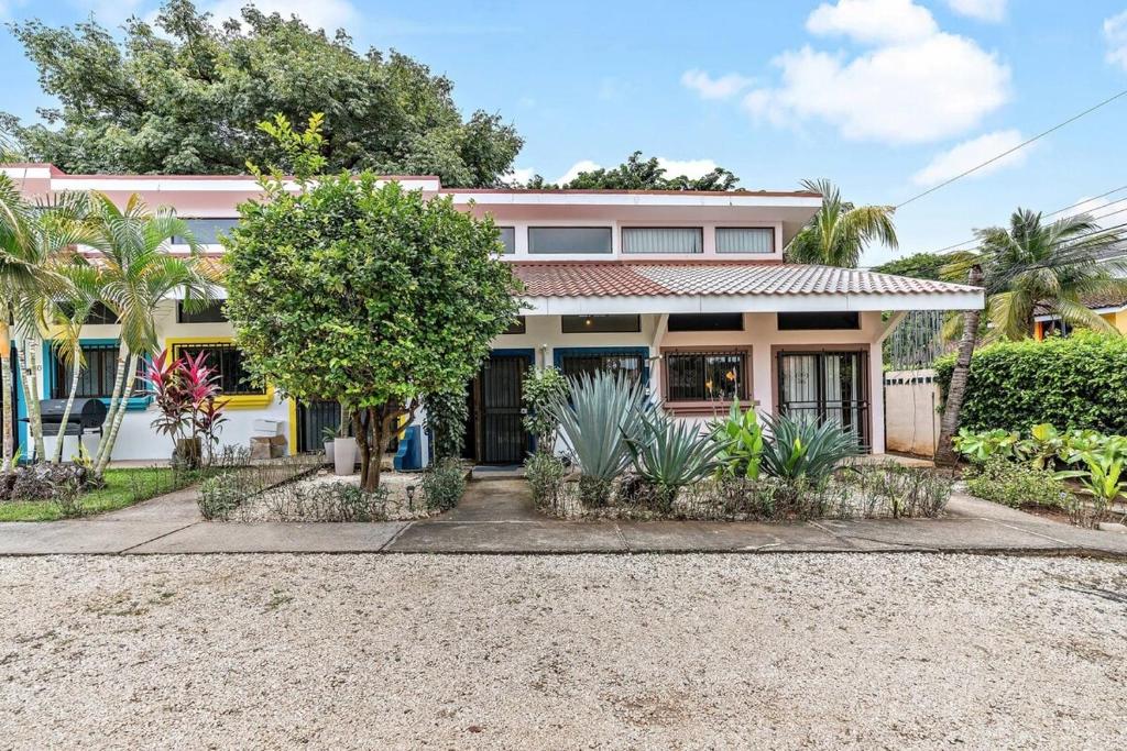 a house with a lot of plants in front of it at Cozy Studio Close to Beach in Coco