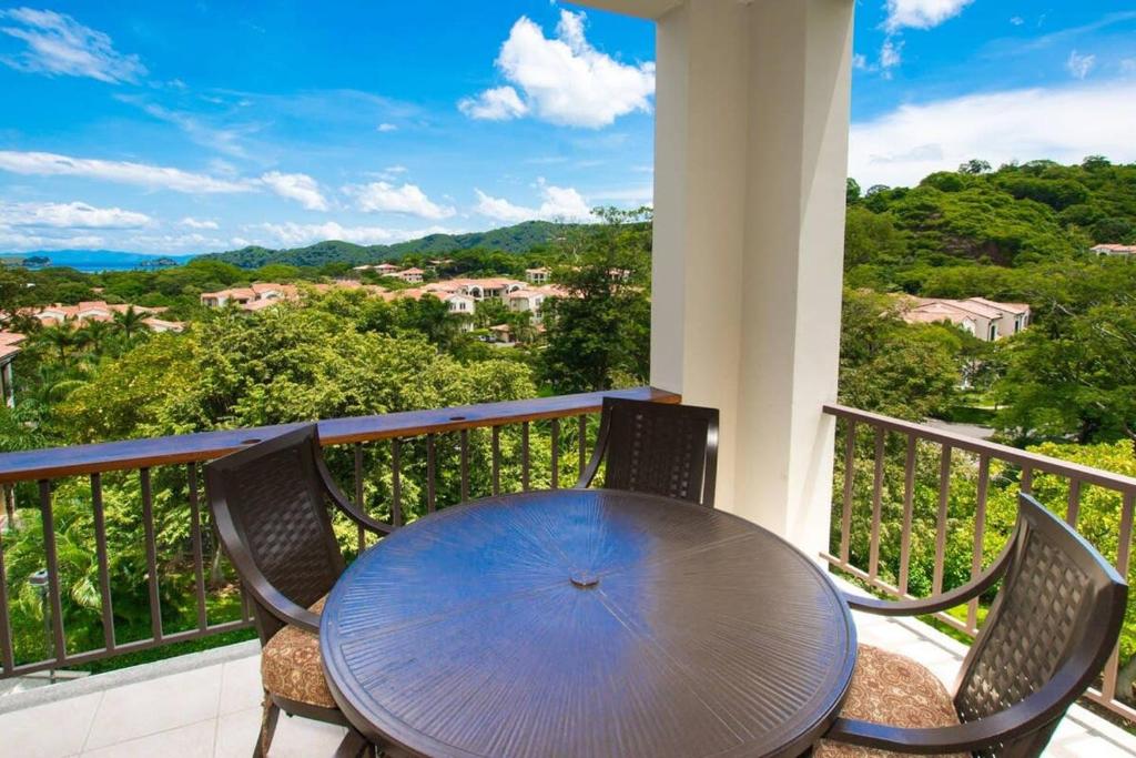 a table and chairs on a balcony with a view at Classy artsy ocean-view unit near pool at Pacifico in Coco sleeps 6 in Coco