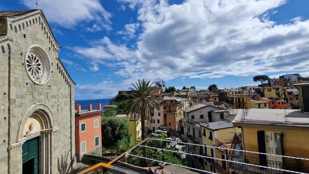a view of a city with a clock tower at Arbanella in Corniglia