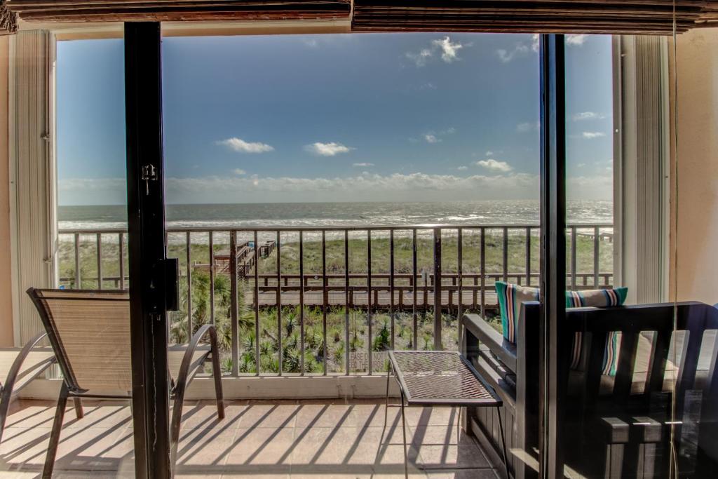 a balcony with a view of the ocean at Oceanfront * Pool * Elevator * Boardwalk in Carolina Beach