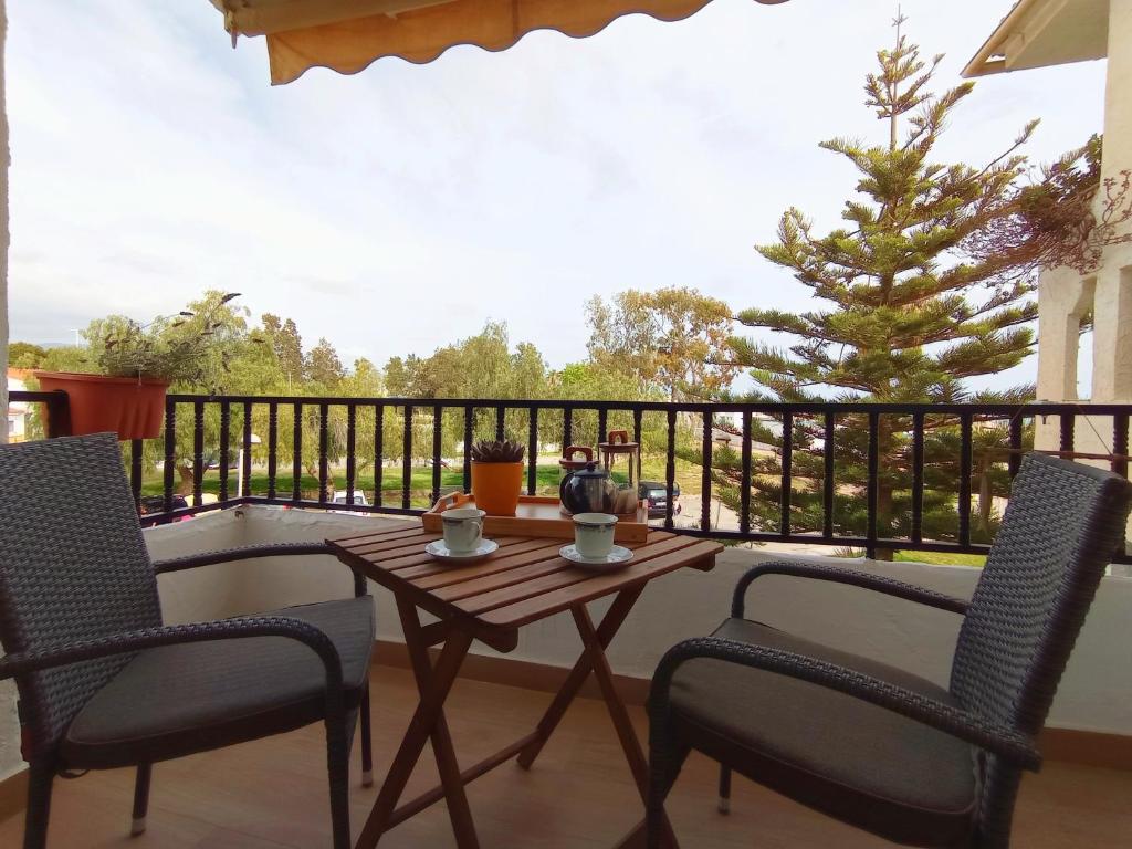 ein Tisch und Stühle auf einem Balkon mit einem Weihnachtsbaum in der Unterkunft Motril Carpe Diem Primera línea de playa in Motril