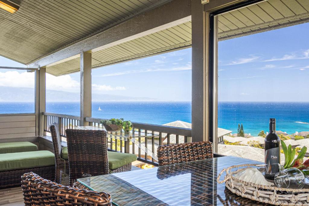 a porch with a table and chairs and the ocean at Kapalua Ridge Villa 1723-24 in Kahana