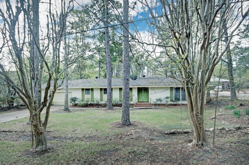 a house with a group of trees in front of it at 4 Bedroom 2 Bath Retreat in Jackson with Great Backyard in Jackson