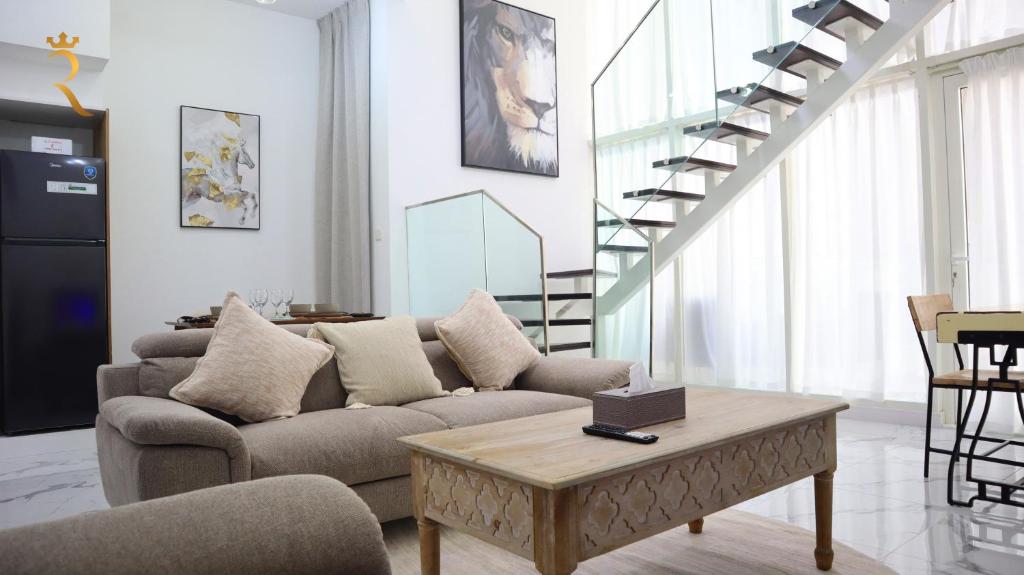 a living room with a couch and a coffee table at Duplex Serenity: Your 2BR Transit apartment. in Abu Dhabi