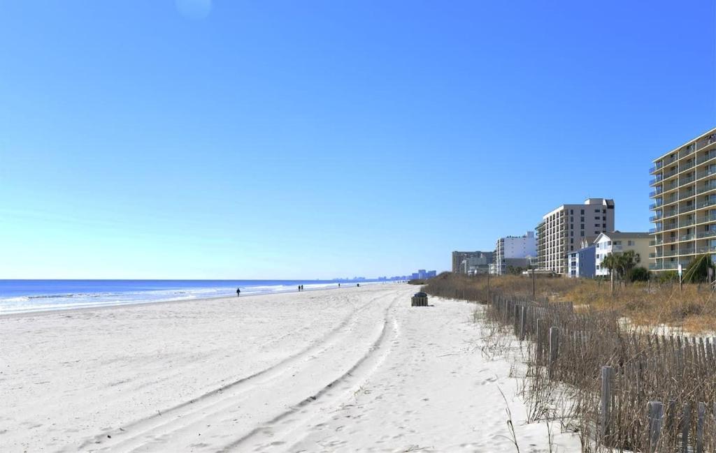 a view of the beach in front of condos at Tropical Rays Huge Cherry Grove House w Pool in Myrtle Beach
