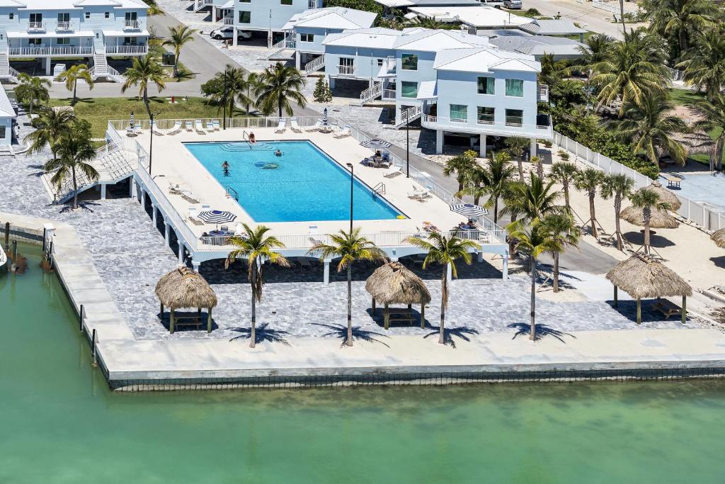 an aerial view of a resort swimming pool with palm trees at Carney's Reef NEW 1B 1B Pool Patio in Marathon